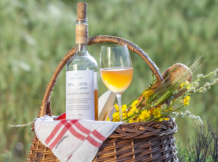 orange wine in picnic basket outdoors